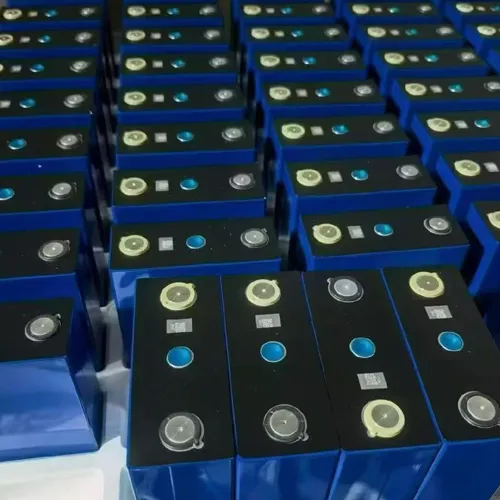 Rows of blue lithium battery modules with terminal contacts in a factory