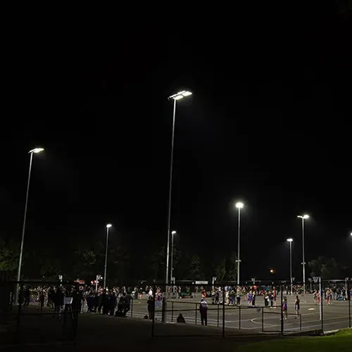 QC LED sports field lights illuminating outdoor courts at night