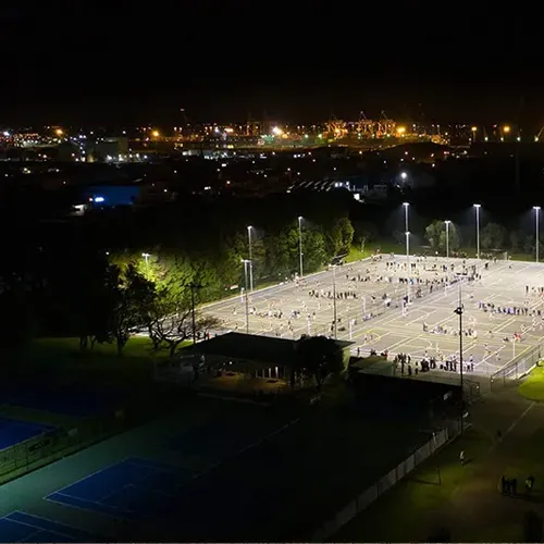 QC LED sports lights illuminating outdoor courts at night