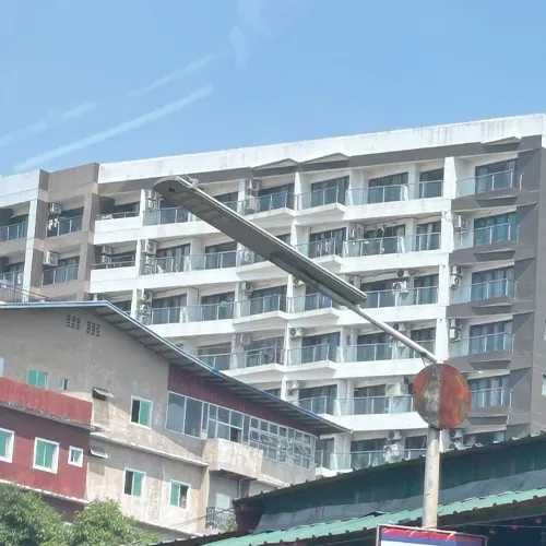 QS Series solar street light installed beside an urban residential building