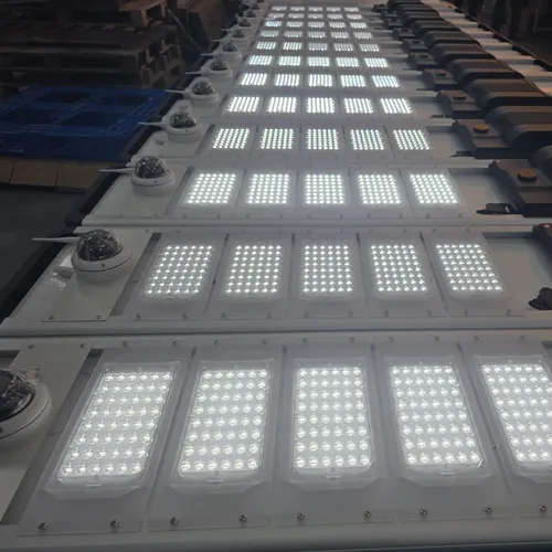 Rows of solar street lights with LED panels and dome cameras in a factory