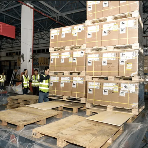 Palletized solar street light products being loaded in a warehouse