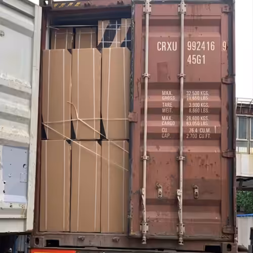 Shipping container loaded with 100 Sungreat Energy solar refrigerators in reinforced cartons, secured with straps for sea freight to Saudi Arabia, showcasing export logistics for off-grid cooling in high-temperature regions