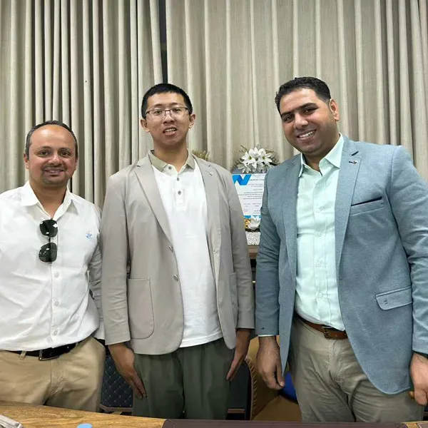 Sungreat Energy founder Boss Adam posing for a photo with Middle Eastern business clients in the corporate office.