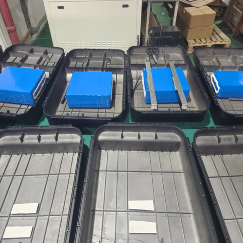 Lithium battery packs being assembled into the housing of 120W integrated solar street lights during production