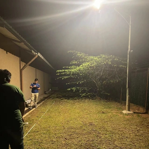 FNC series all in one solar street light with camera illuminating a residential yard at night real case