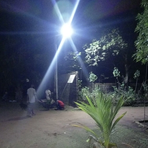 FNC series integrated solar street light with built-in camera illuminating a community road at night